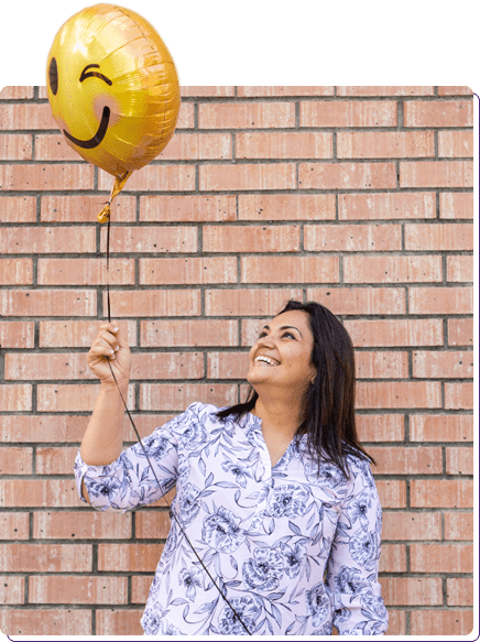 Dr. Meghna Dassani with a Smiley Face Balloon